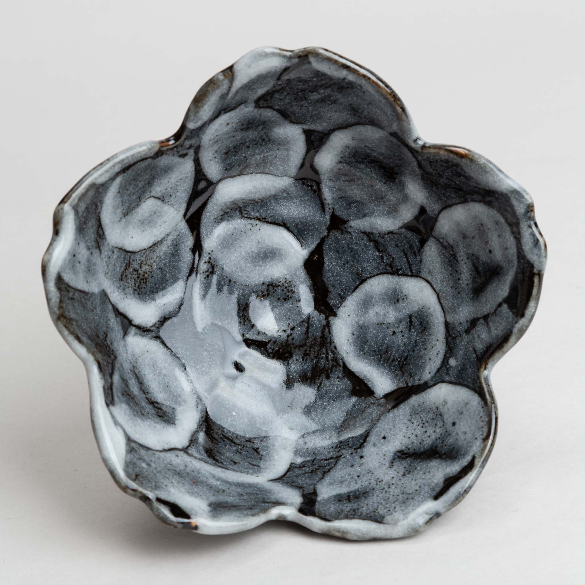228-5857 Flower shaped white on black mid bowl